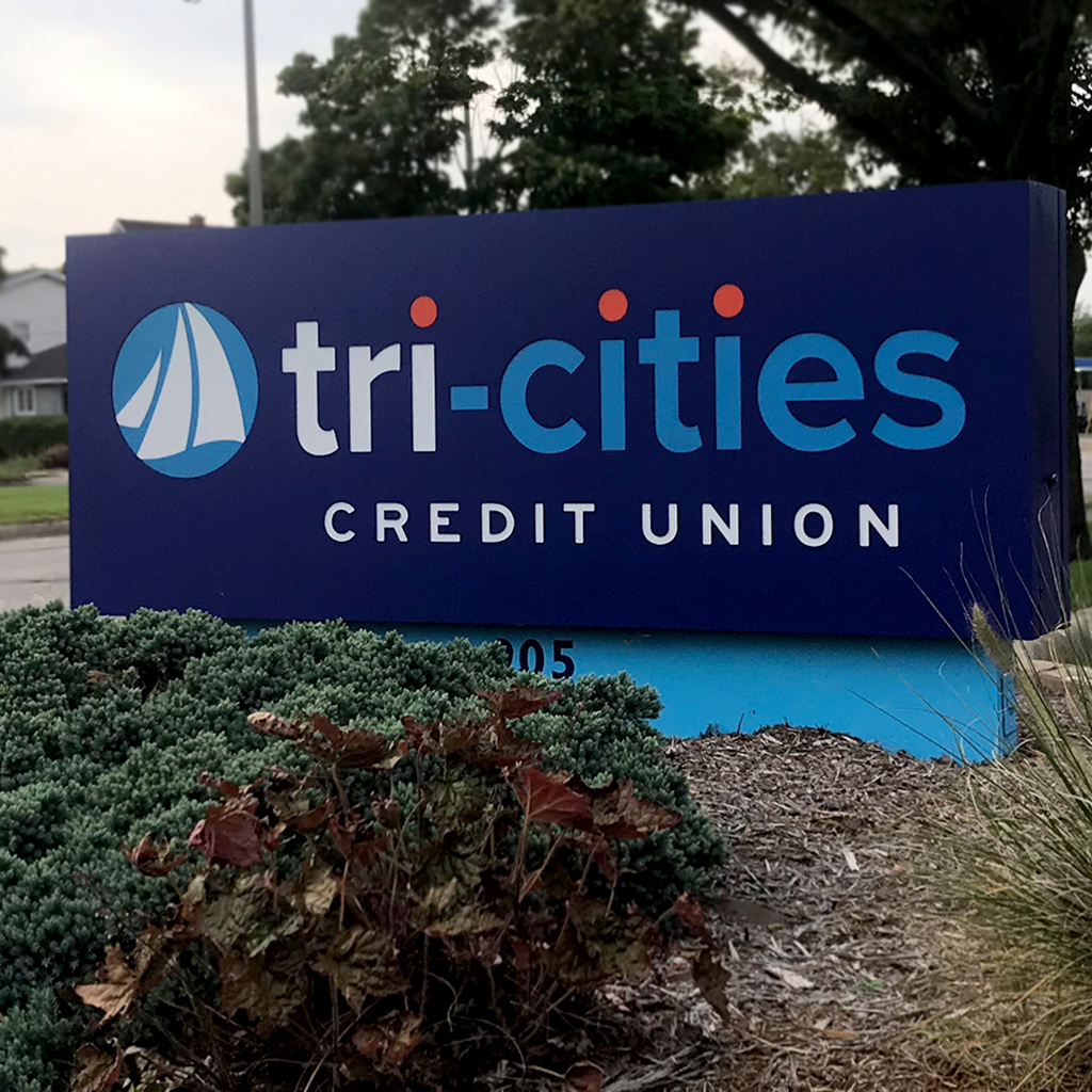 Photograph on the Tri-Cities Credit Union sign in a parking lot.