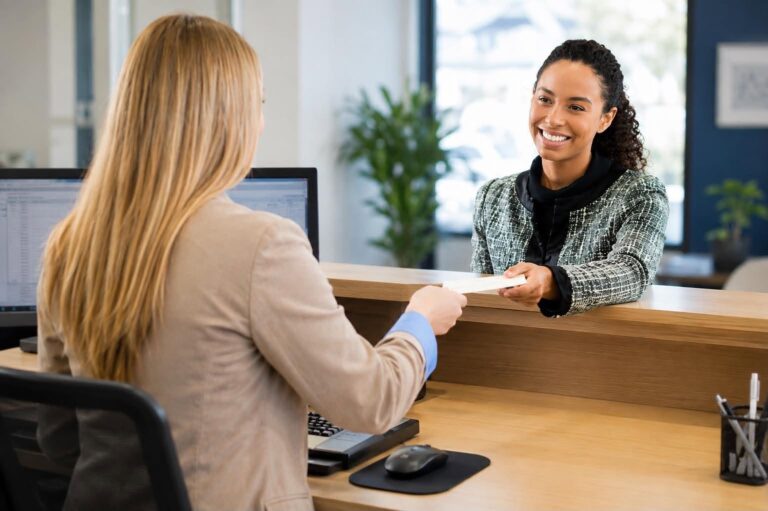 Teller helping customer at bank.